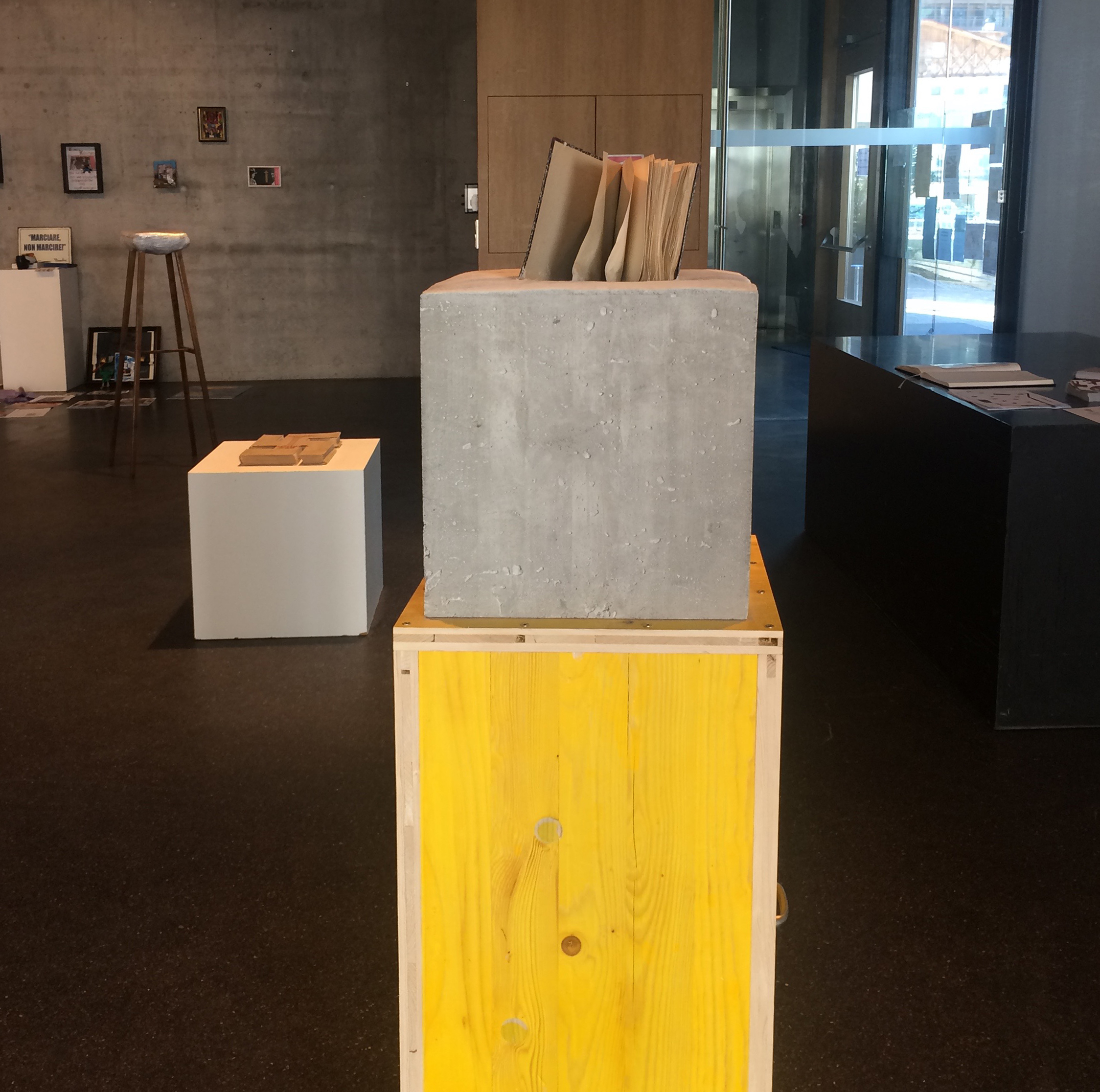 concrete sculpture with book, book sculpture